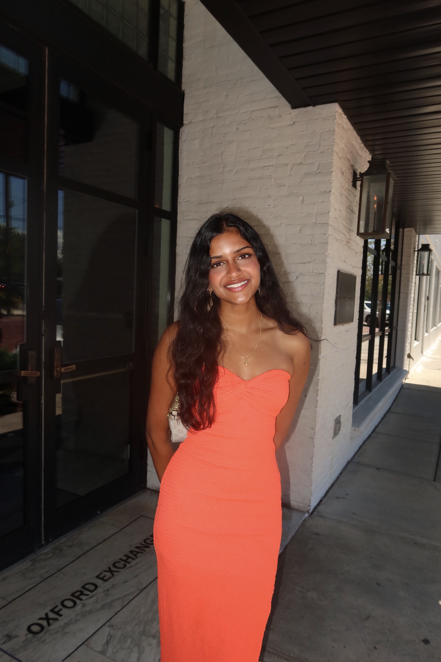 Kirthi Jaladi in an orange dress