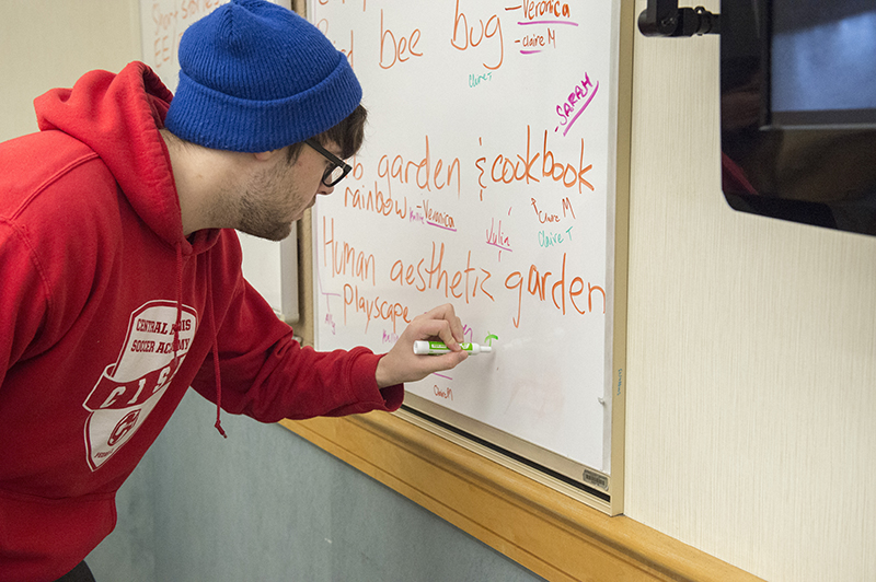 SIU Honors student writes on a board